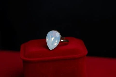 White gold ring with a large stone on a red velvet box Stock Photos