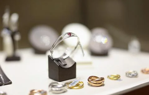 White gold ring with ruby on shop window closeup Stock Photos
