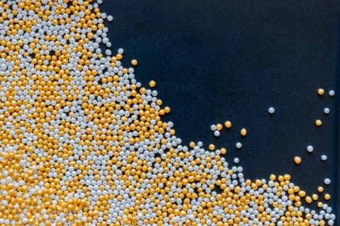 White, Gold, Shiny and Tiny Sugar Balls Background 库存照片