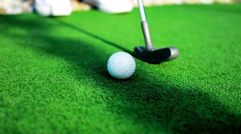 White golf ball on green grass in sunny day Stock Footage 56607090