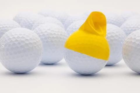 White golf balls with funny cap on the white background. 스톡 사진