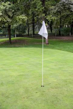 White golf flag on a field Stock Photos