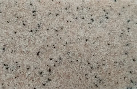White granite with black splashes close-up. Background, texture. Close-up. Stock Photos