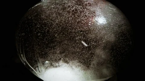White Granular Snow Bubbles in Glassware on a Black Background Stock Footage 61312386