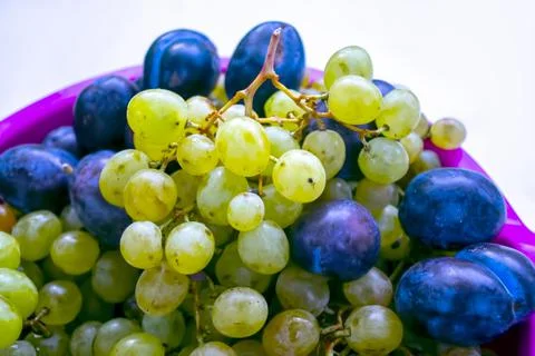 White grape and plums, fruit background Stock Photos