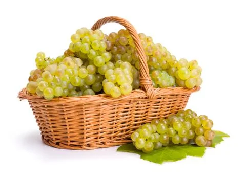 White grape clusters in basket Stock Photos