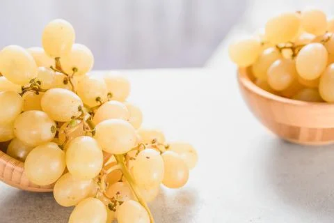 White grapes in a basket on a table Stock Photos