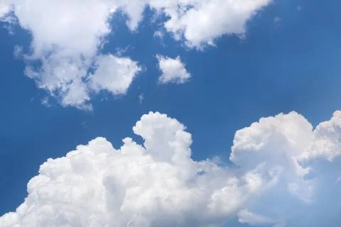 White gray clouds in clear blue sky background Stock Photos