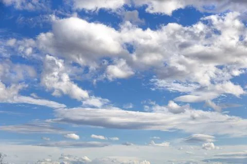 White-gray clouds fly across the blue sky. Texture of clouds and sky Stock Photos