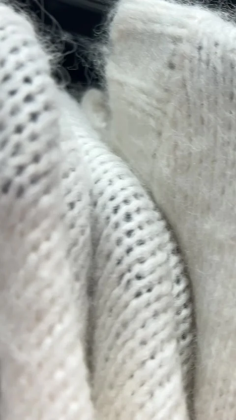 White, gray, grey, blue warm wool sweater, clothes on hanger in clothing shop Stock Footage 334203703