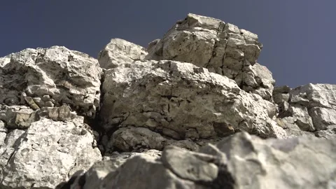 White gray limestone bedrock forms a stepped tectonic landscape - Rugged Ground Stock Footage 339402032
