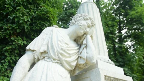 White greek statue on a background of trees and vines 스톡 동영상 115033421