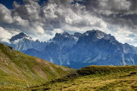 White grey clouds over Sexten Dolomites peaks and crags Italy Stock Photos