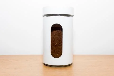 White ground coffee container filled with coffee powder Stock Photos
