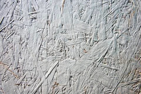 White grunge painted one layer oriented strand board OSB. Vintage OSB. Close  Stock Photos