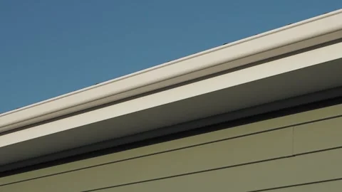 White Gutter and Downspout System at Modern House - Rainwater Drainage Solution Stock Footage 301066997
