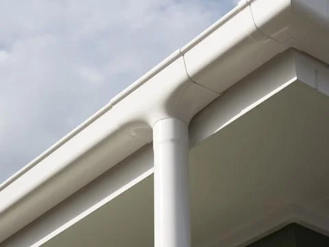 White Gutter and Downspout System on Modern House - Rainwater Drainage Soluti Stock Photos