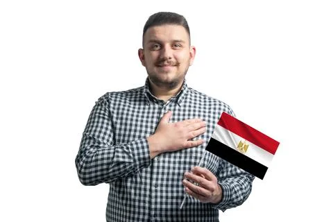 White guy holding a flag of Egypt and holds his hand on his heart isolated on Stock Photos