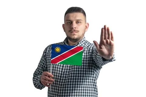 White guy holding a flag of Namibia and with a serious face shows a hand stop Stock Photos