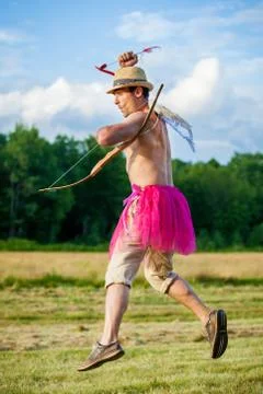 White guy with wings on his back. He displays bow with arrow. Cupid on Valent Stock Photos
