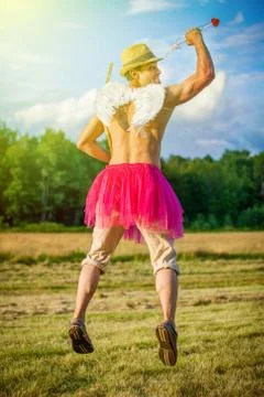 White guy with wings on his back. He displays bow with arrow. Cupid on Valent Stock Photos