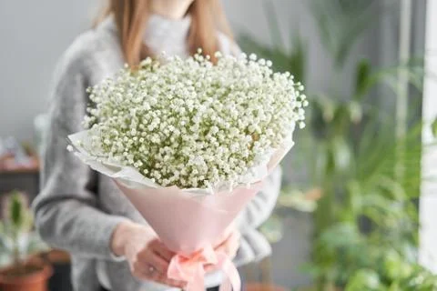 White gypsophila. Beautiful bouquet of mixed flowers in womans hands. the work Stock Photos