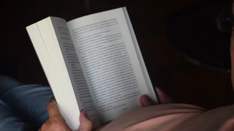 White haired man reads a book Stock Footage 267621617