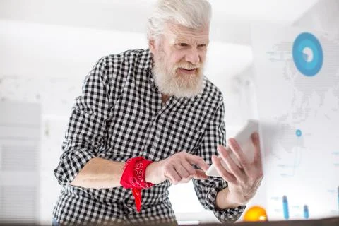 White-haired senior man checking data from screen Stock Photos