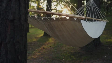 White hammock in garden, close-up. Empty hammock for relaxing Stock Footage 126665292