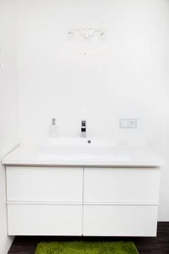 White hand basin unit in a bathroom Stock Photos