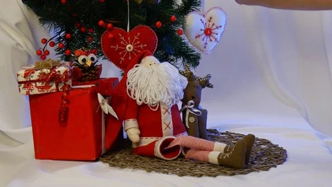 White Hand Made Heart is Being Hung on a Fir Tree and Two Photo Frames Are Stock Footage 72548947