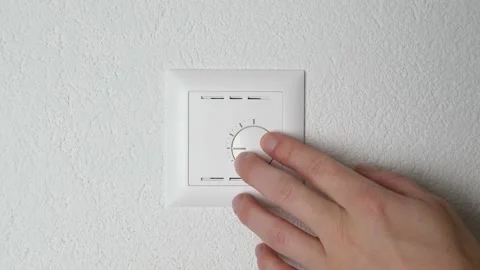 White hand raise room temperature with a modern heating switch. Video stock 147848805