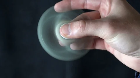 White hand spinner, or fidgeting spinner, rotating on child's hand Stock-Footage 76781926