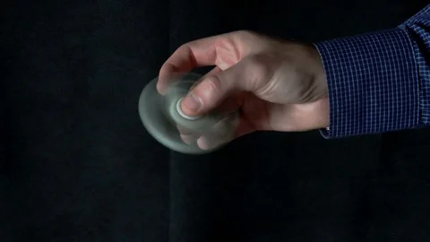 White hand spinner, or fidgeting spinner, rotating on child's hand Vídeos de archivo 76782231