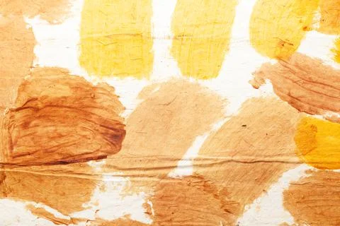 White handmade rough paper with multiple golden yellow colored stains Стоковые фото