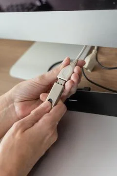 White hands plugging a pendrive into computer Foto stock