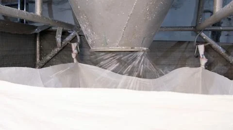 White hard grinded plastic comes out of the cyclone of the machine by pneumatic Stock Photos