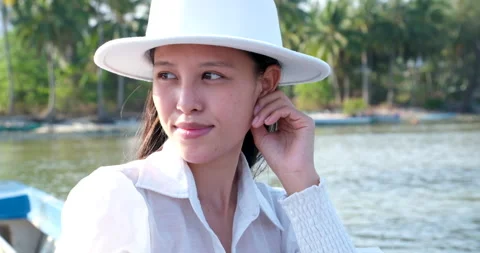 White hat outdoors face of young sunshine woman in straw hat look at ocean beach Stock Footage 307674792