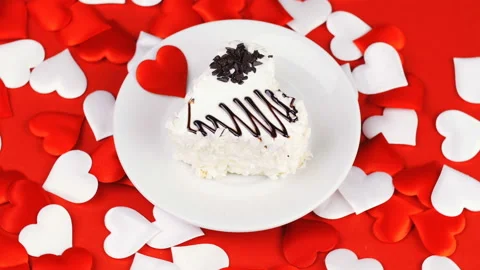 White heart cake with chocolate icing on a red background. Stock Footage 101674554