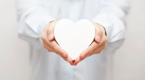 White heart in hands Stock-Fotos