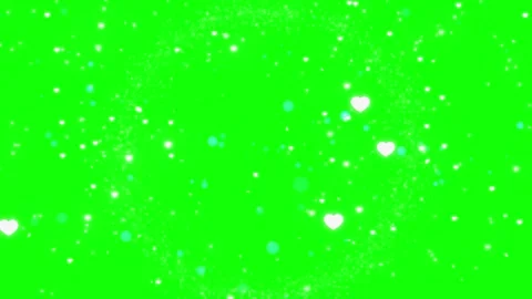 White heart particles floating in a circular motion on a green screen 库存影片 343908703