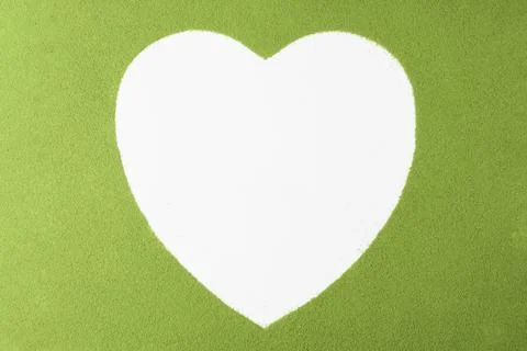White heart shape cut out in vibrant matcha green powder evokes love, nature, Фото