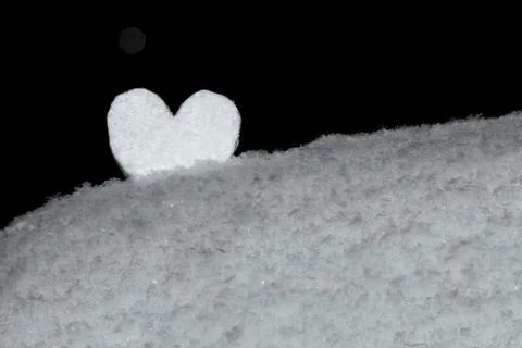 White heart on snow in a snowdrift Stock Photos