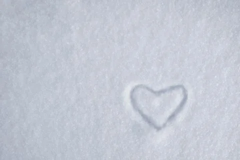 White heart on snow in a snowdrift Stock Photos