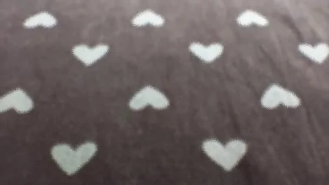 White hearts geometric seamless pattern, with black blurred background. Stock Photos