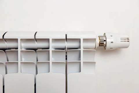 White heating radiator hanging on white wall, close up view. Central heating 스톡 일러스트