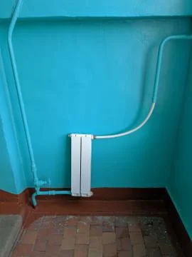 A White heating radiator on the wall. Stock Photos