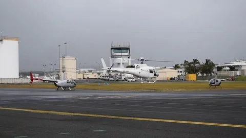 White helicopter taking off with boeing 737 taking off in background Video stock 76563385