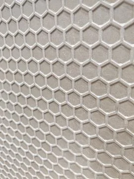 White Hexagonal Mesh Pattern on Grey Textured Background 库存照片