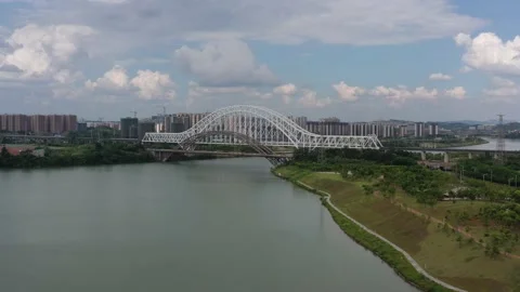 A white high-speed bullet train is passing a railway bridge in China Stock Footage 234574949